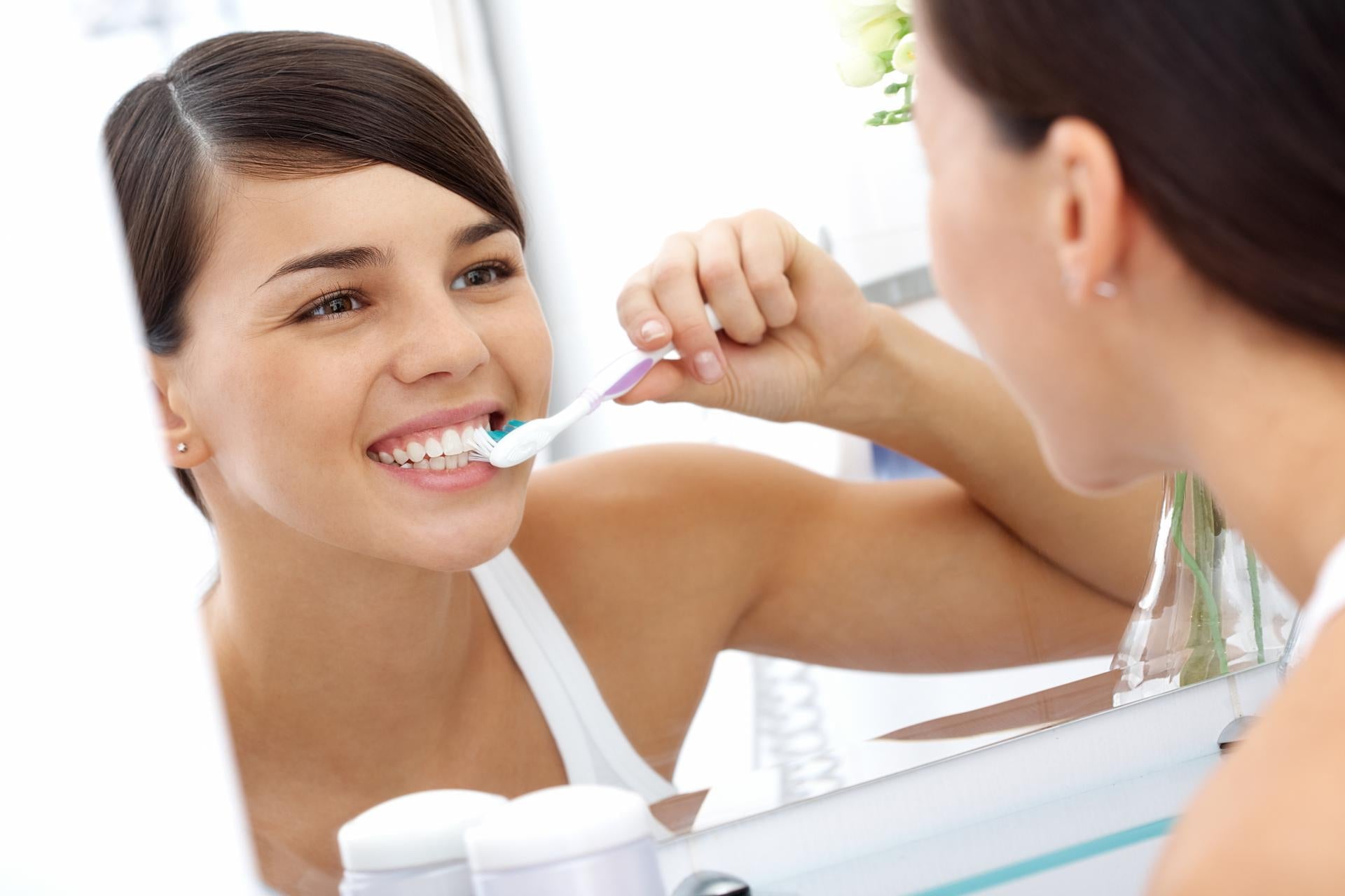 Man Smiling while using Lauricidin Natural Toothpaste