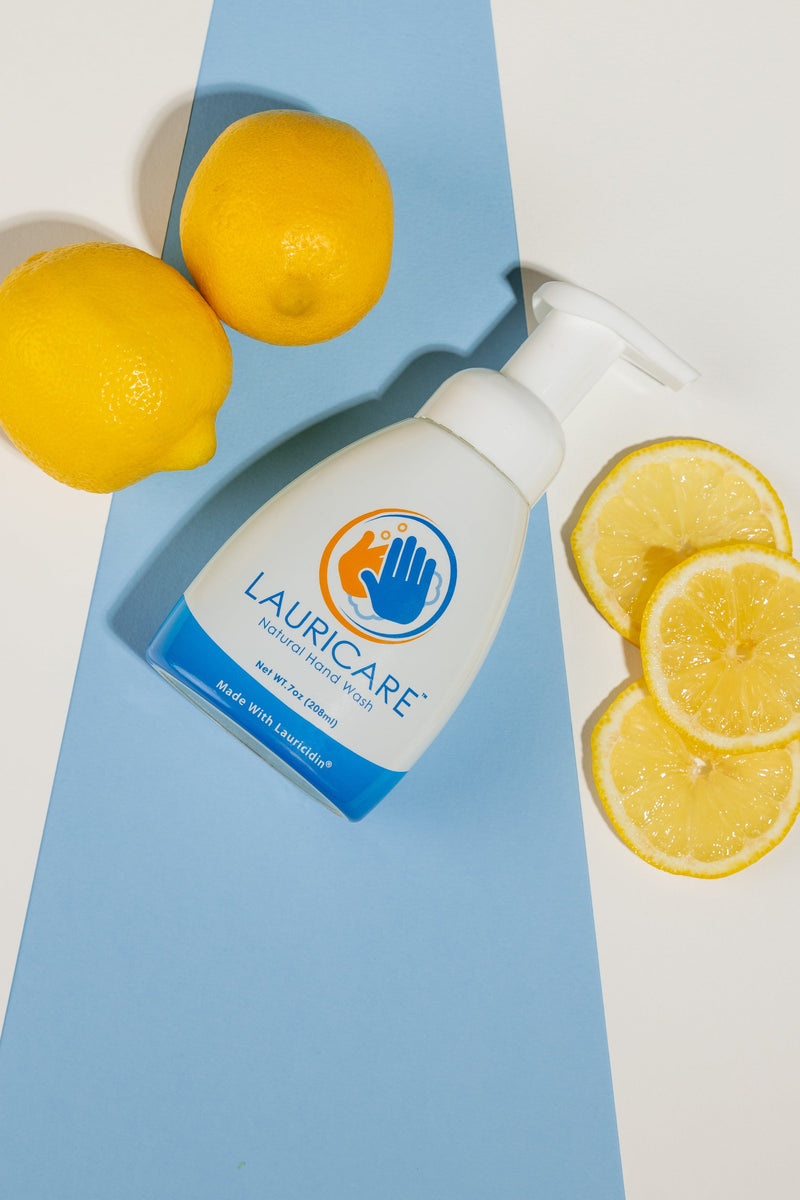 Lauricare bottle with lemons on a blue and white background