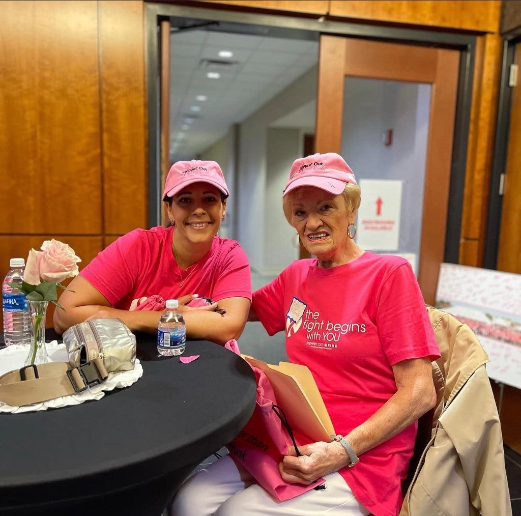 Betty Kabara at Steppin' Out in Pink, wearing a pink cap and a shirt that reads the fight begins with you.
